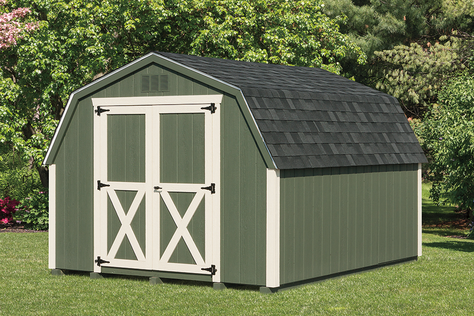 A green garden shed with cream double doors and a gambrel roof in a grassy yard in charlotte nc